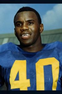 Photo of Ron Johnson wearing a blue football uniform with yellow number 40. 