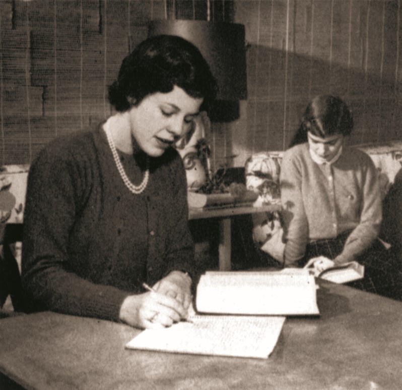A woman taking notes for a class