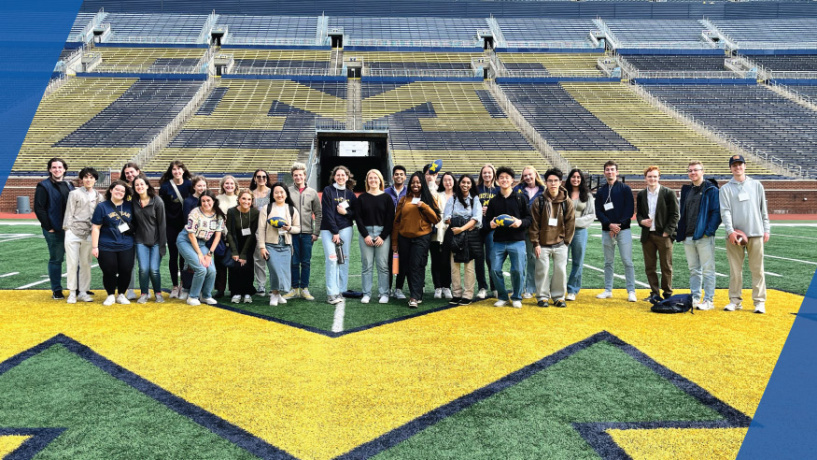 OYM students standing on the field in the Big House